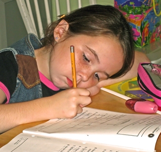 Featured is a picture of one very studious young lady doing her homework ... whether one is homeschooled or attends school in the classroom, it's all about learning.  Photo taken by and used courtesy of Sam LeVan of Philadelphia, PA.